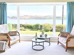 a living room with a view of the ocean at Taigh An Uillt in Tighnabruaich