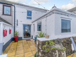 an exterior view of a house with a patio at Tyr Llyr in Penclawdd