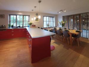 a large kitchen with a long island and a dining room at Shielside in Acharacle