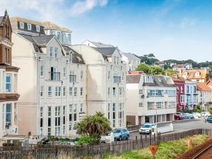 a group of buildings in a city with a street at Waves - Great Cliff in Dawlish