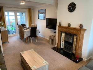 a living room with a fireplace and a dining room at Paignton View in Paignton