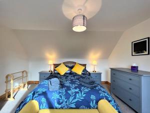 a bedroom with a bed and two night stands at Hirta Cottage in Staffin