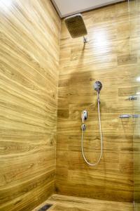 a bathroom with a shower with a wooden wall at Luxury Seafront Appartement 6-7p in Agadir