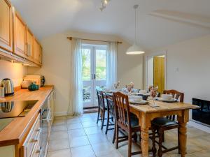 a kitchen with a wooden table and chairs in a kitchen at Fair View in Donington on Bain
