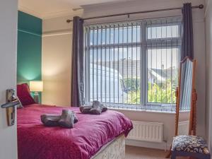 a bedroom with a bed with a large window at Hill View in Preston
