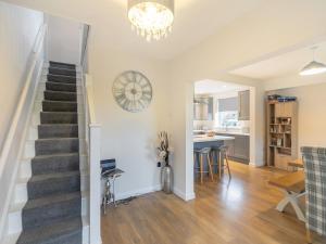 a living room and kitchen with a staircase and a dining room at Carr View Farm in Bamford
