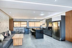 a kitchen and living room with a couch and a table at Luxury Seafront Appartement 6-7p in Agadir