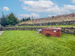 a smallshed in a yard with a stone wall at Cefn Y Meirch in Bala