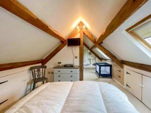 a bedroom with a white bed in a attic at Cefn Y Meirch in Bala