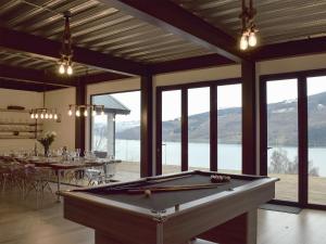 a pool table in a room with a view of a lake at Chapelburn in Lawers