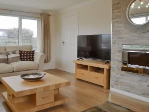 a living room with a large flat screen tv at Stepping Stones in Trearddur