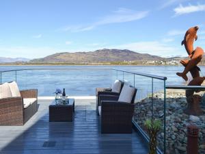 a balcony with chairs and a view of the water at 4 Dolphins in Connel