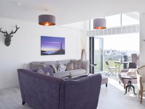 a living room with a couch and a table at The Lookout in Portpatrick