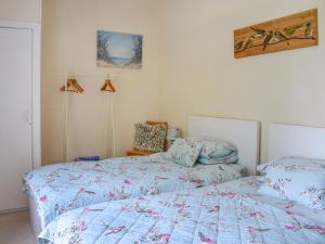 a bedroom with two beds with blue comforter at Bryn Melyn - Uk6518 in Frongoch