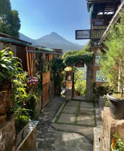 an alley in a village with a mountain in the background at Umah De Madya & Rooftop De Madya in Munduk