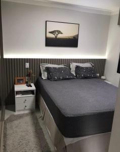 a bedroom with a bed and a tree on the wall at Apartamento Congonhas 2207 torre Suites in Sao Paulo +18 photos