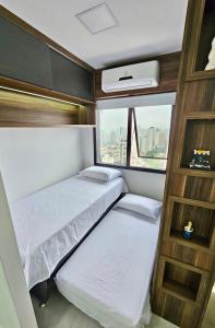 a bedroom with two beds and a window at Apartamento Congonhas 2207 torre Suites in Sao Paulo