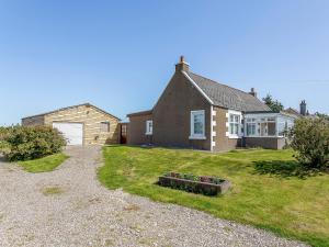 a house with a grass yard in front of it at Inverspey in Kingston