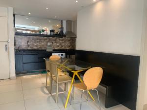 a kitchen with a glass table and chairs at Real Apartments 255 - High level Copacabana 2 bedrooms close to Ipanema in Rio de Janeiro