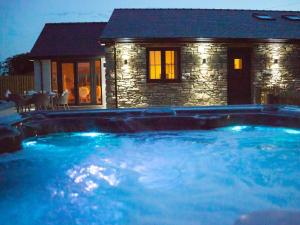 una gran piscina frente a una casa en Stabl en Cross Inn