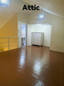 an empty room with an attic with a wooden floor at Big House In Alor Setar Taman Sri Ampang in Alor Setar