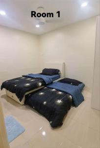 a room with a bed with blue sheets on it at Big House In Alor Setar Taman Sri Ampang in Alor Setar