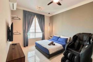 a bedroom with a blue bed and a black chair at COZY Modern Spacious 8pax S PICE Penang in Bayan Lepas