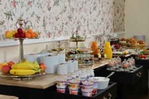 a buffet with fruit and other food on a table at Hotel Domstern in Cologne