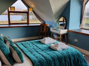 a bedroom with a large bed and a mirror at Shielside in Acharacle
