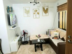 a living room with a couch and a table at Family Staycation in Tagaytay in Tagaytay