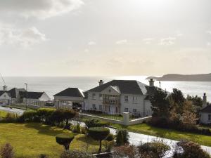 a row of houses with the ocean in the background at Bay View in Carlyon Bay