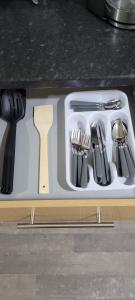 a white cutting board with utensils on a counter at 13 Decent Homes in Dukinfield