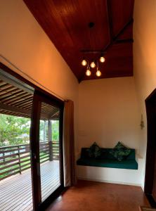 a bedroom with a bed and a door to a deck at Turtle Bay Village in São Miguel do Gostoso