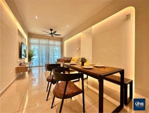 a dining room and living room with a table and chairs at Midori Green By RR JBcity in Johor Bahru