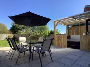 a table and chairs with an umbrella on a patio at Oakland in Fleetwood