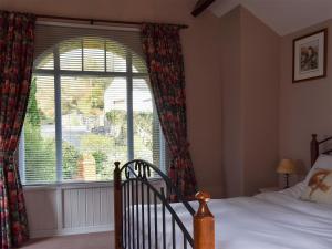 a bedroom with a bed and a large window at Twinkleberry Barn in Lorton