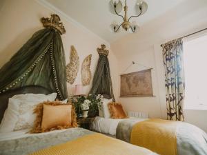a bedroom with two beds and a chandelier at Wild Geese Lodge - Uk31046 in Portpatrick