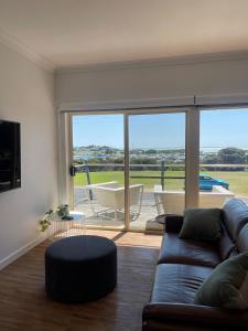 a living room with a couch and a large window at Harbour View Motel in Robe