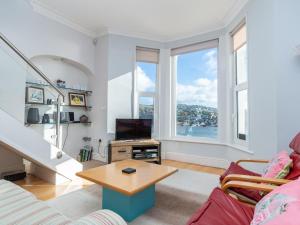 a living room with a couch and a table at Apartment 2 The Wheelhouse in Fowey