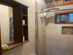 a bathroom with a shower with a shower head at Hostería CASA SAN LUIS in Quito