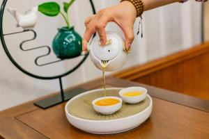 a person pouring soup into two bowls on a table at Fanjian Inn-Xi'an Drum Tower & Muslim Cultural District in Xi'an