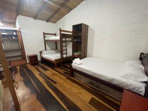 a room with two bunk beds and a ladder at Hostería CASA SAN LUIS in Quito