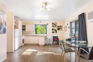 A kitchen or kitchenette at Relaxed Urangan Living at the Poolside Bungalow