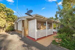 a small house with a satellite dish on top of it at Relaxed Urangan Living at the Poolside Bungalow in Urangan