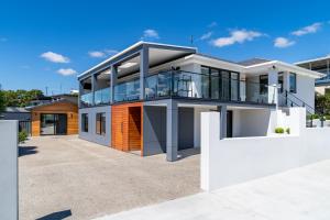 a modern house with a lot of glass at Beach Walk on Alfred in Bridport