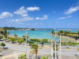 a view of a body of water with palm trees at Hotel Miyakojima in Miyako-jima