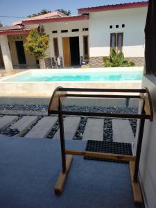 a glass bed in front of a swimming pool at Scar Reef Homestay in Jereweh