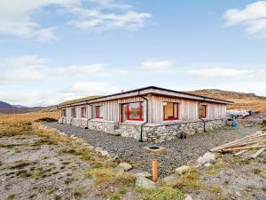 a building with red doors on the side of it at Riof Bay - Uk31251 in Valtos