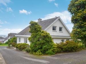 uma casa branca com um telhado cinzento em Swn-y-wylan em Criccieth