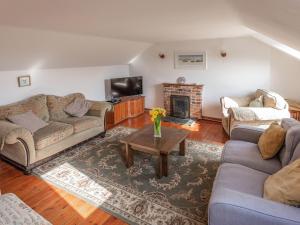 a living room with two couches and a fireplace at The Cottage - Uk10514 in Carbis Bay